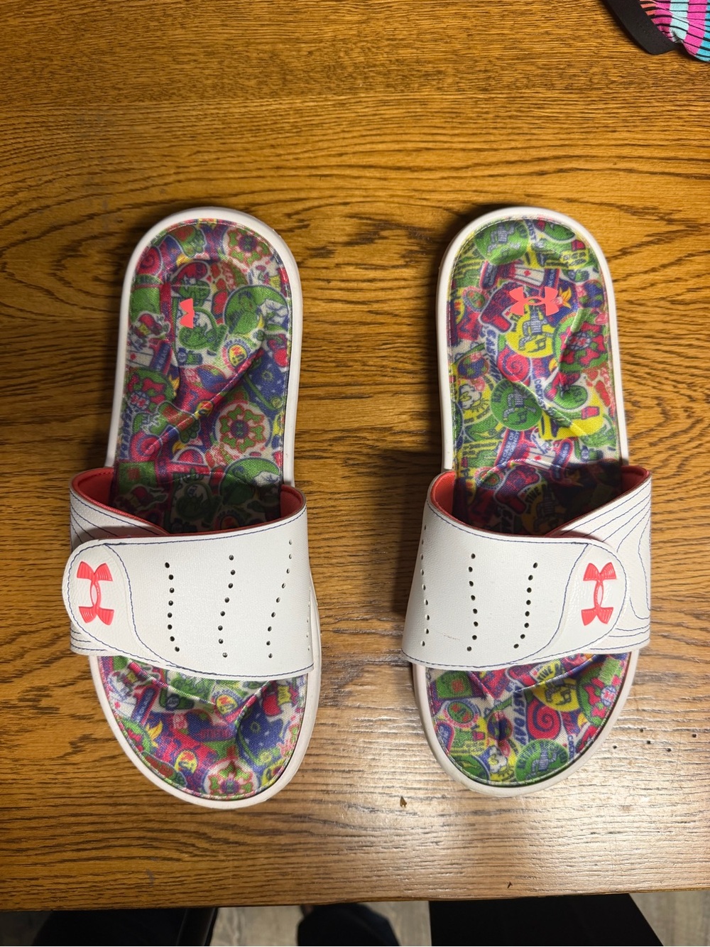 Under Armour women’s  White Slides with Orange Logo and Colorful Printed Footbed